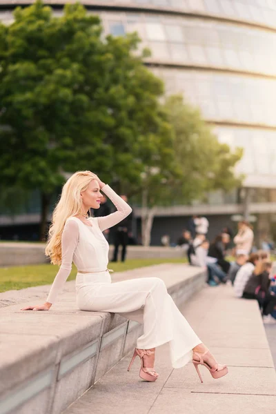 Elegant blonde woman full body portrait in London. Real lifestyl
