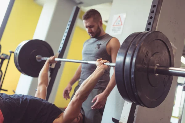 Young Man Lifting Barbell Gym Friend Helping Him Concept Active — Stok fotoğraf