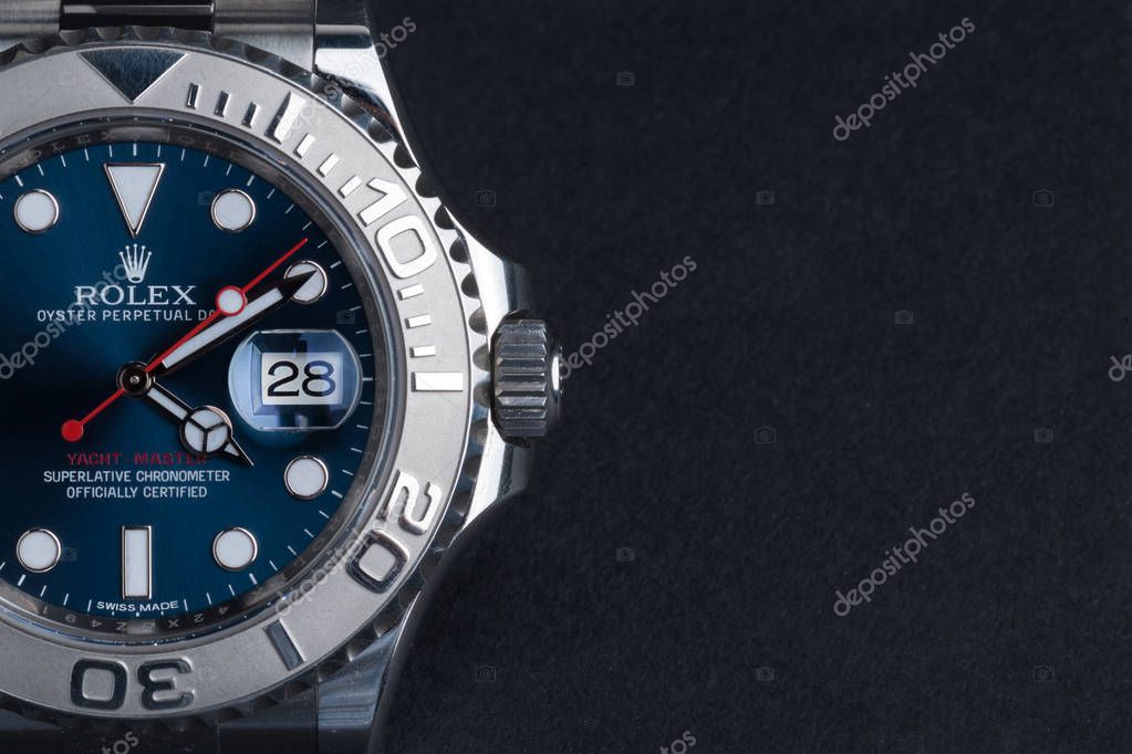 Rolex Oyster Perpetual Date Yacht Master watch on dark background.