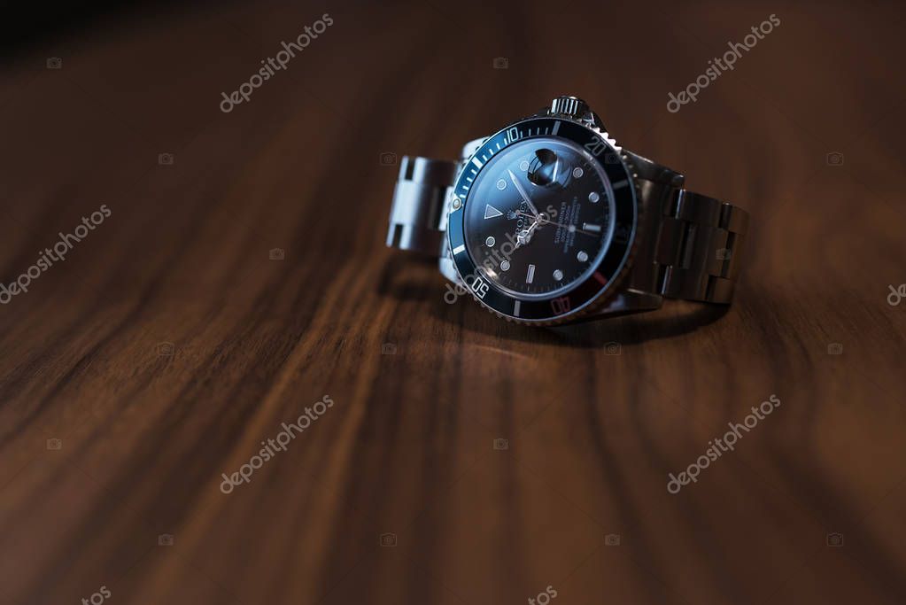 Rolex Submariner watch on wooden table on wooden table