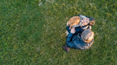 Romantic senior couple portrait playing outdoors in the park, winter time. Aerial view from drone.