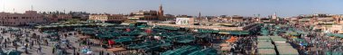 MARRAKECH, MOROCCO - APRIL 2019: Unidentified people on the Jemaa el Fna Square. The square is part of the UNESCO World Heritage. High resolution image made by different photos stitched together. clipart