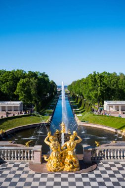 SAINT PETERSBURG, RUSSIA - MAY, 2018: Terrace and Golden statues inside Grand cascade of Peterhof. The Peterhof Palace is included in the UNESCO's World Heritage List. clipart