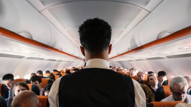 LONDON, UNITED KINGDOM - CIRCA MAY, 2018: Steward working inside Easy Jet airplane at Gatwick Airport.