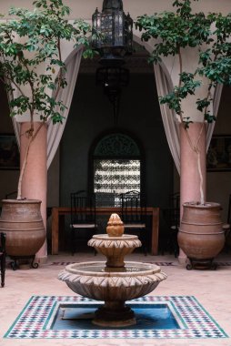 MARRAKECH, MOROCCO - APRIL 2019: Traditional Moroccan riad, interior courtyard view. A riad is a type of traditional Moroccan house or palace with an interior garden or courtyard. clipart