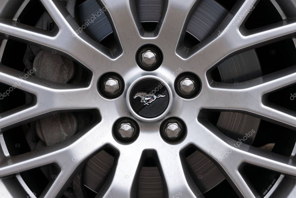 LONDON - JUNE, 2018: Mustang Pony symbol on wheel detail. The Ford Mustang is an American automobile manufactured by Ford.