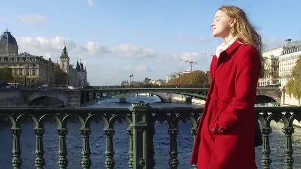 Young blonde woman with red coat portrait walking in the streets — Stock Video