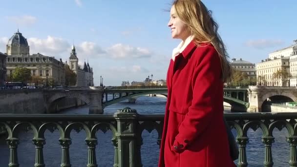 Young blonde woman with red coat portrait walking in the streets — Stock Video