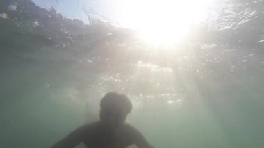 Underwater woman footage wearing a pink bikini swimming pool. 