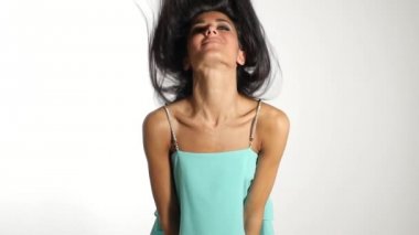 Woman wearing posing  against white wall background. 