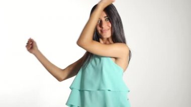 Woman wearing posing  against white wall background. 