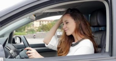 young woman  sitting  in her car.
