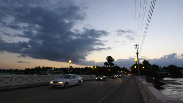 美しい夕日の空の下で橋の上を移動する車 — ストック動画