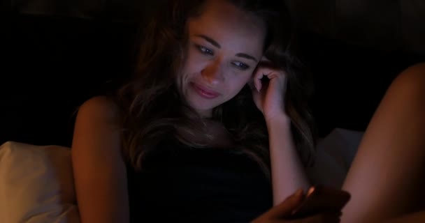 Młoda Uśmiechnięta Kobieta Zbliżyć Portret Domu Patrząc Trzymając Telefon Łóżku — Wideo stockowe