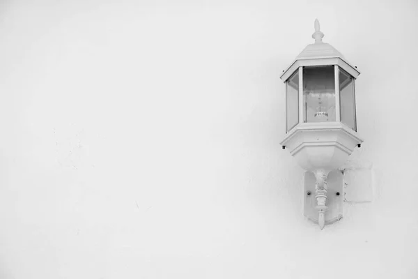 White silver outdoor lamp on white house wall with copy space