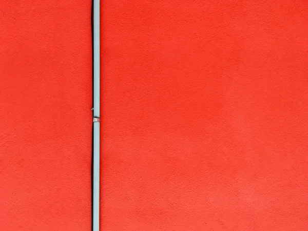 Tubo na parede vermelha — Fotografia de Stock