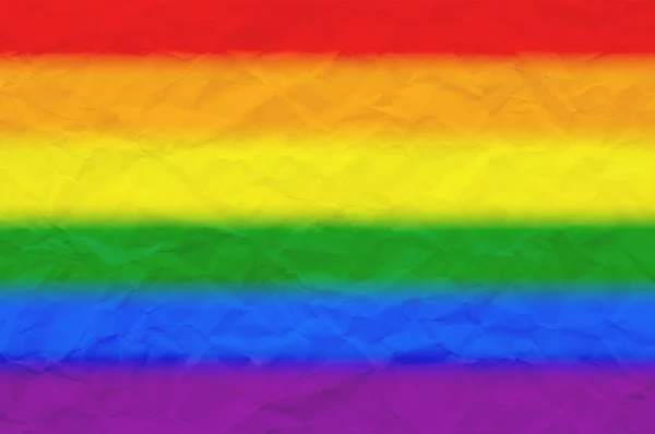 Lgbt骄傲旗或彩虹骄傲旗在皱折的纸为背景 — 图库照片