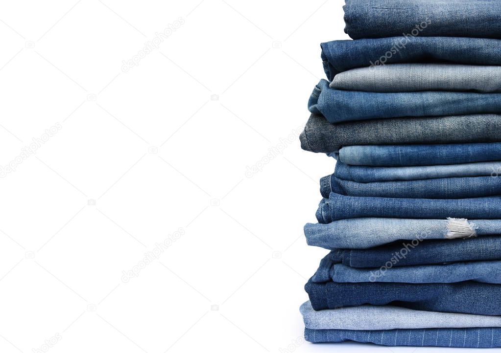 Stack different blue pants, with jeans texture isolated on white background.