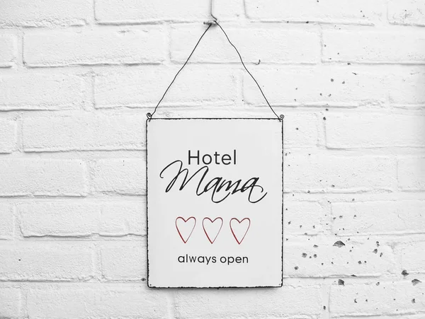 Hotel mama always open mothers day gift red love hearts on white brick background