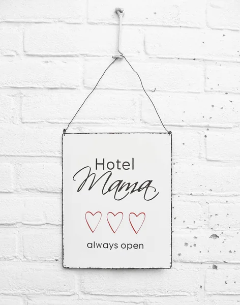 Text Hotel mama always open quote for mothers day banner with red hears on white brick background mothersday gift