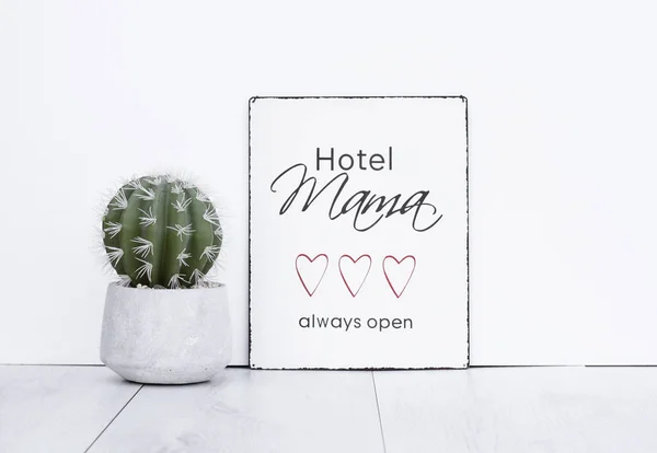 Mothersday gift text board hotel mama always open hipster background with cactus plant in concrete pot