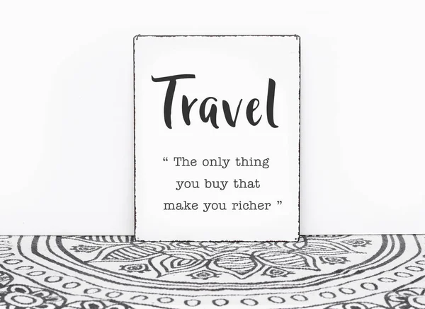 Bohemian vintage carpet travel quote travel is the only thing you buy that makes you ricer text on board white isolated wall background