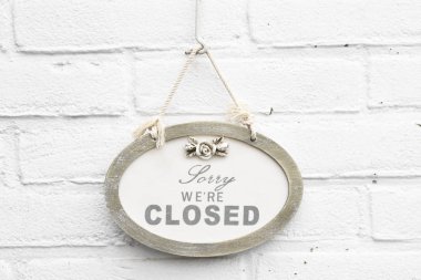 Cute antique sign board with sorry we're closed today clipart