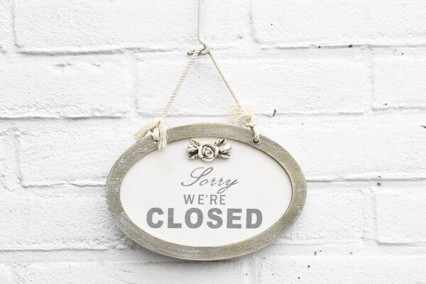 Cute antique sign board with sorry we're closed today