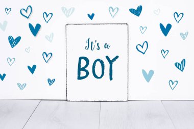 Bu sevimli küçük mavi kalp şekilleri ile tabela üzerinde bir çocuk yeni doğmuş bebek metin