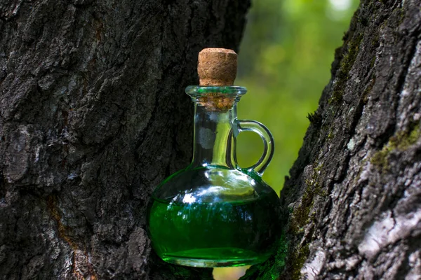 Magic green glass bottle with potion. Magic drink.