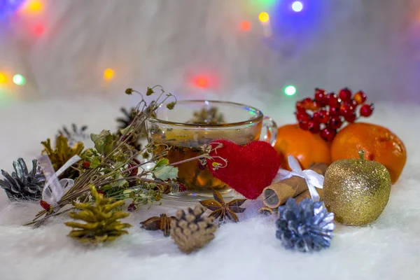 Hot black tea Christmas decor. Tea and dry medicinal strawberry on white background.