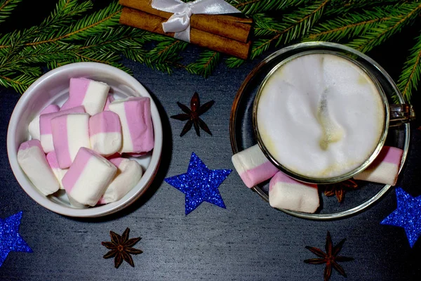 Christmas holiday atmosphere. Hot Cup of black coffee and sweet marshmallows.