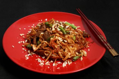 Çin noodle ile sığır istiridye sosu altında yumurta. Marine edilmiş Dana eti, havuç, kereviz ve lahana, sulu kuşkonmaz, payet zencefil yapıştırın, istiridye sosu, soya sosu.