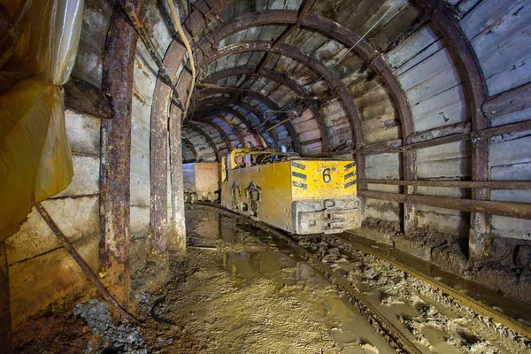 Electric locomotive in underground mine tunnel