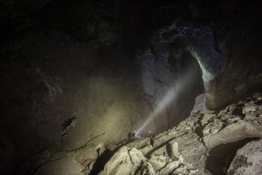 Demir madeni yeraltında. Büyük tükenmiş havuz mağarası madencilerle dolu.