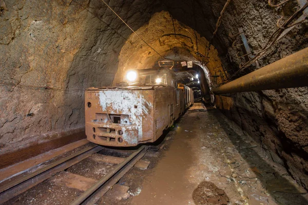 Electric locomotive in underground mine tunnel