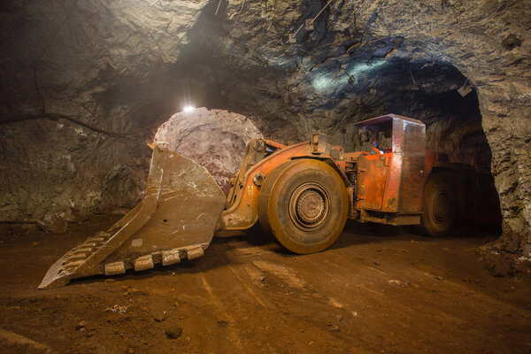 Underground gold iron ore mine tunnel with LHD machine