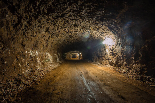 Underground gold iron ore mine shaft tunnel gallery passage with light