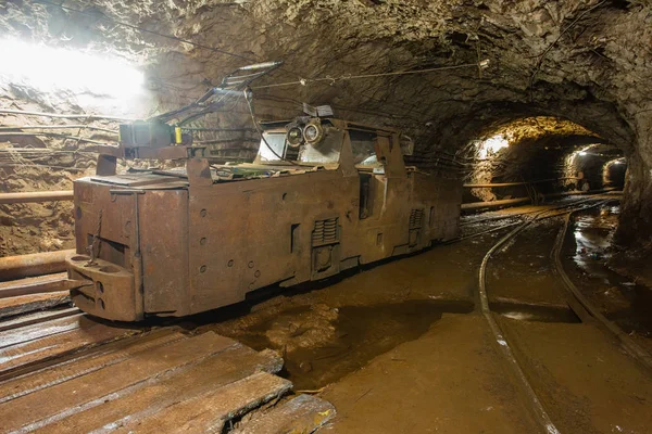 Electric locomotive in underground mine tunnel