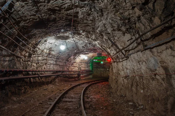Underground abandoned gold iron ore mine shaft tunnel gallery passage wtih railway