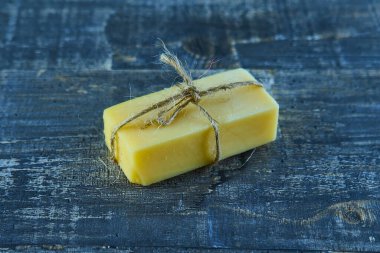 Sarı peynir, soyulmuş ceviz ve mavi ahşap bir masada kabuklu ceviz.