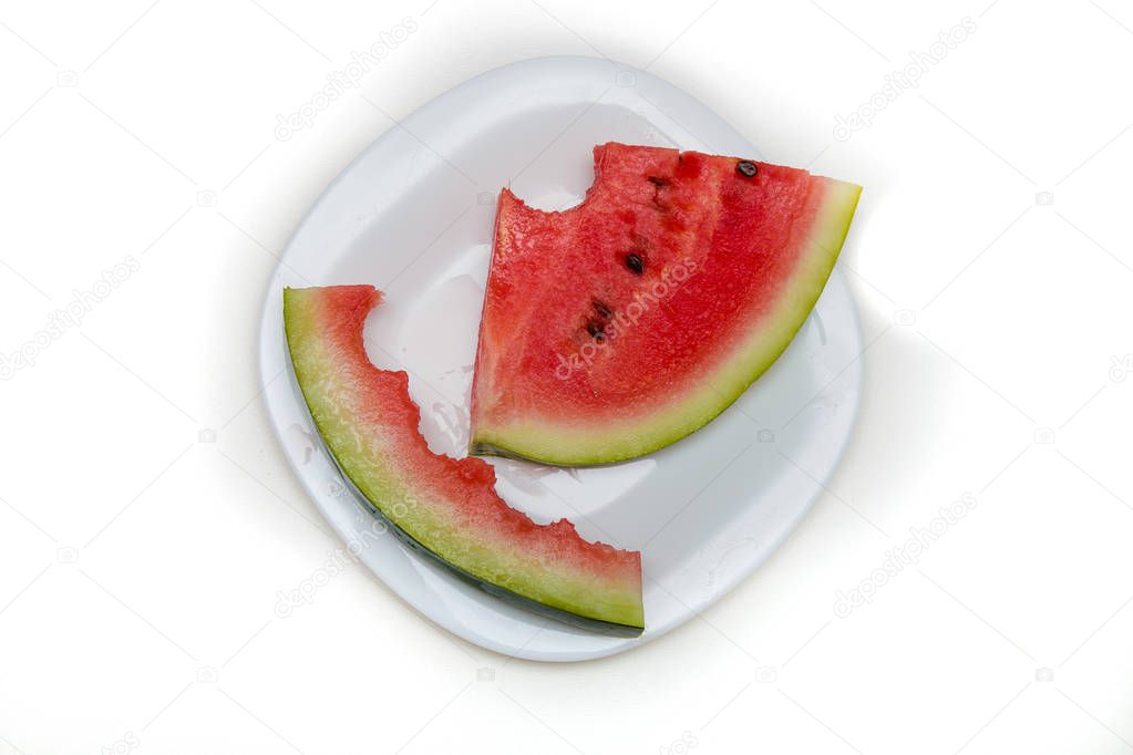 slice and peeled watermelon peel on a white plate white background isolation top view