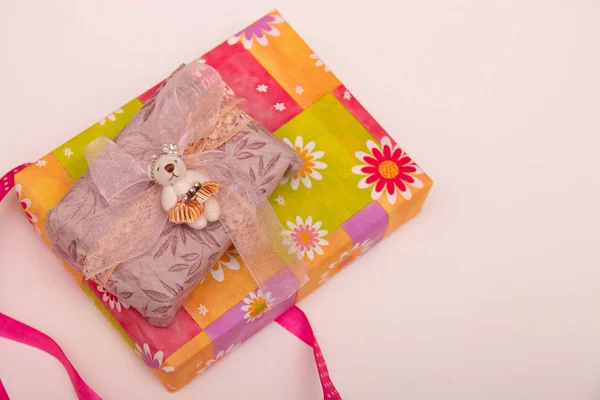 gifts in boxes on a white background place copy top view golden ribbon with bow wrapped in brown paper purple ribbon braid cute bears for decoration bright colorful