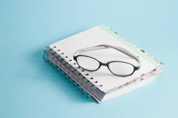 Children Glasses Lie Notebook Blue Background Copy Space Gray Bending Royalty Free Stock Photos