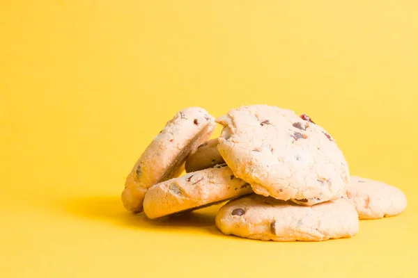cookies on a yellow background, cookies with pieces of chocolate and lingonberry