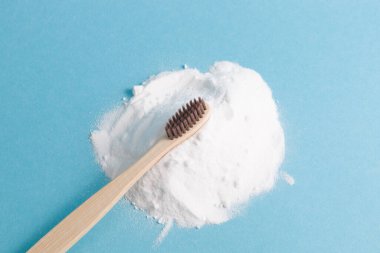 Mavi arka planda bir yığın soda üzerine bambu diş fırçası. Fotokopi, diş fırçası, gazoz konsepti, sıfır atık yaşam tarzı konsepti.