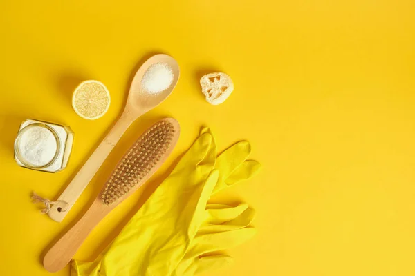 no waste cleaning kit on yellow background, zero waste lifestyle, eco cleaning concept, soda and lemon for cleaning