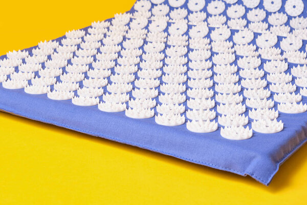blue massage acupuncture mat with white massage tips, massage mat for relaxation and treatment of back and body pain