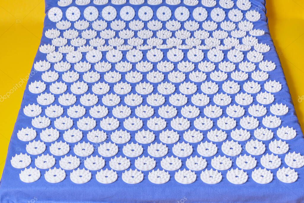 blue massage acupuncture mat with white massage tips, massage mat for relaxation and treatment of back and body pain