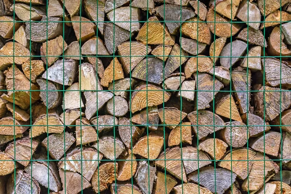 Firewood behind bars. — Stock Photo, Image